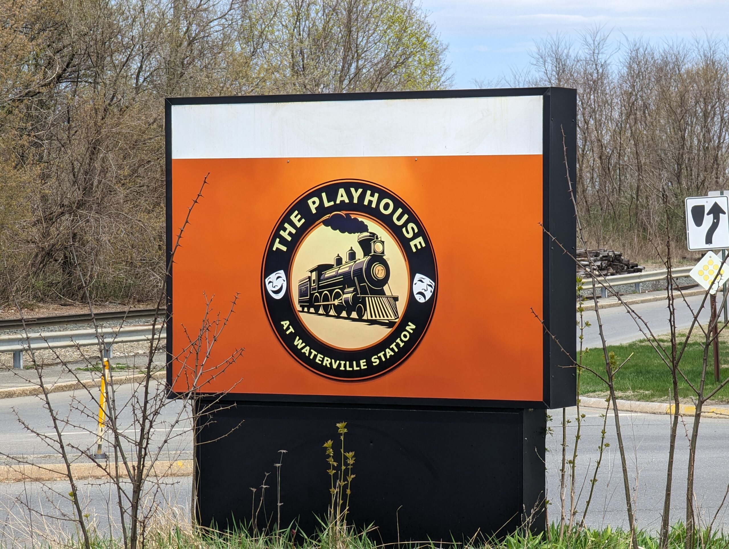 The roadside sign with the logo for The Playhouse At Waterville Station